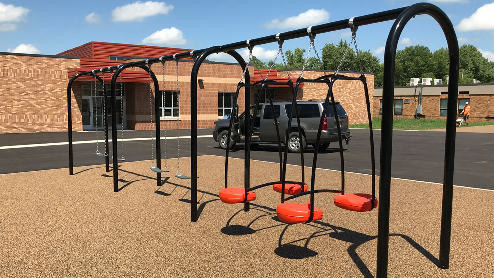Black and red swing set for an elementary school